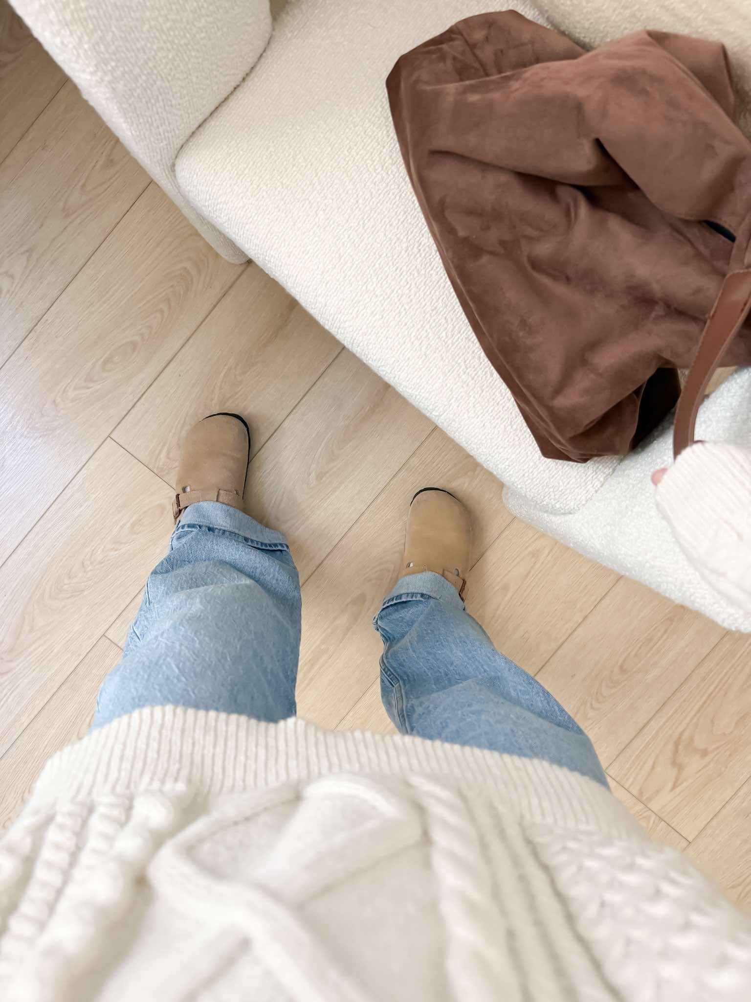 Taupe Birkenstock clogs outfit with jeans and a cream sweater for casual fall shoe styling