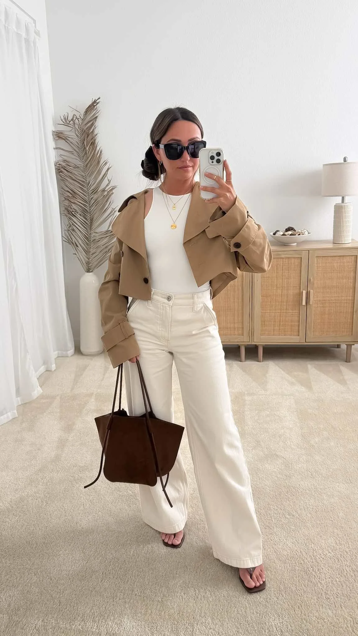 Warm weather fall outfit with white wide-leg jeans with a tank top and cropped trench jacket