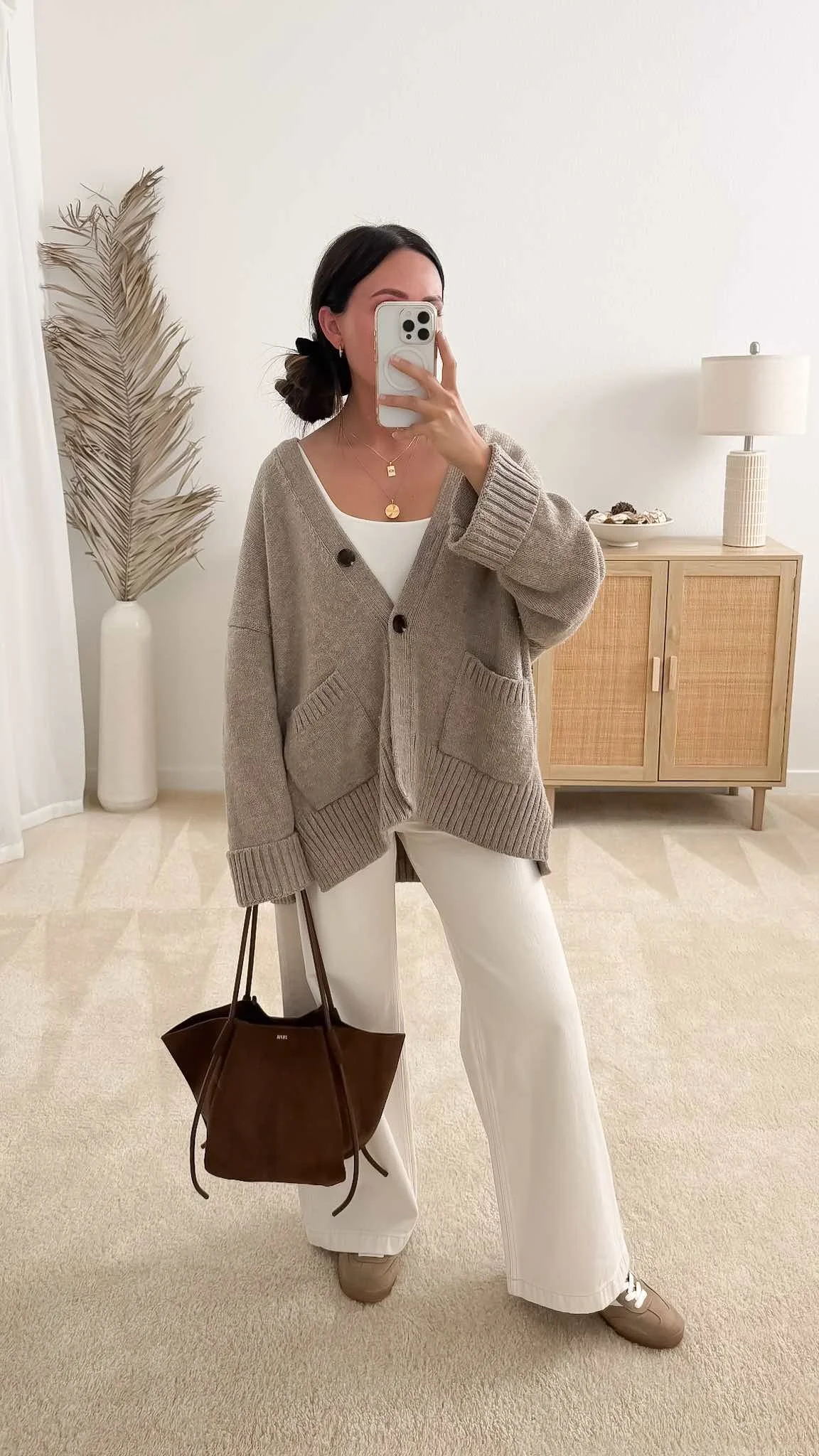 Taupe cardigan layered over a white tank with cream wide leg pants and taupe sneakers for a casual fall outfit.