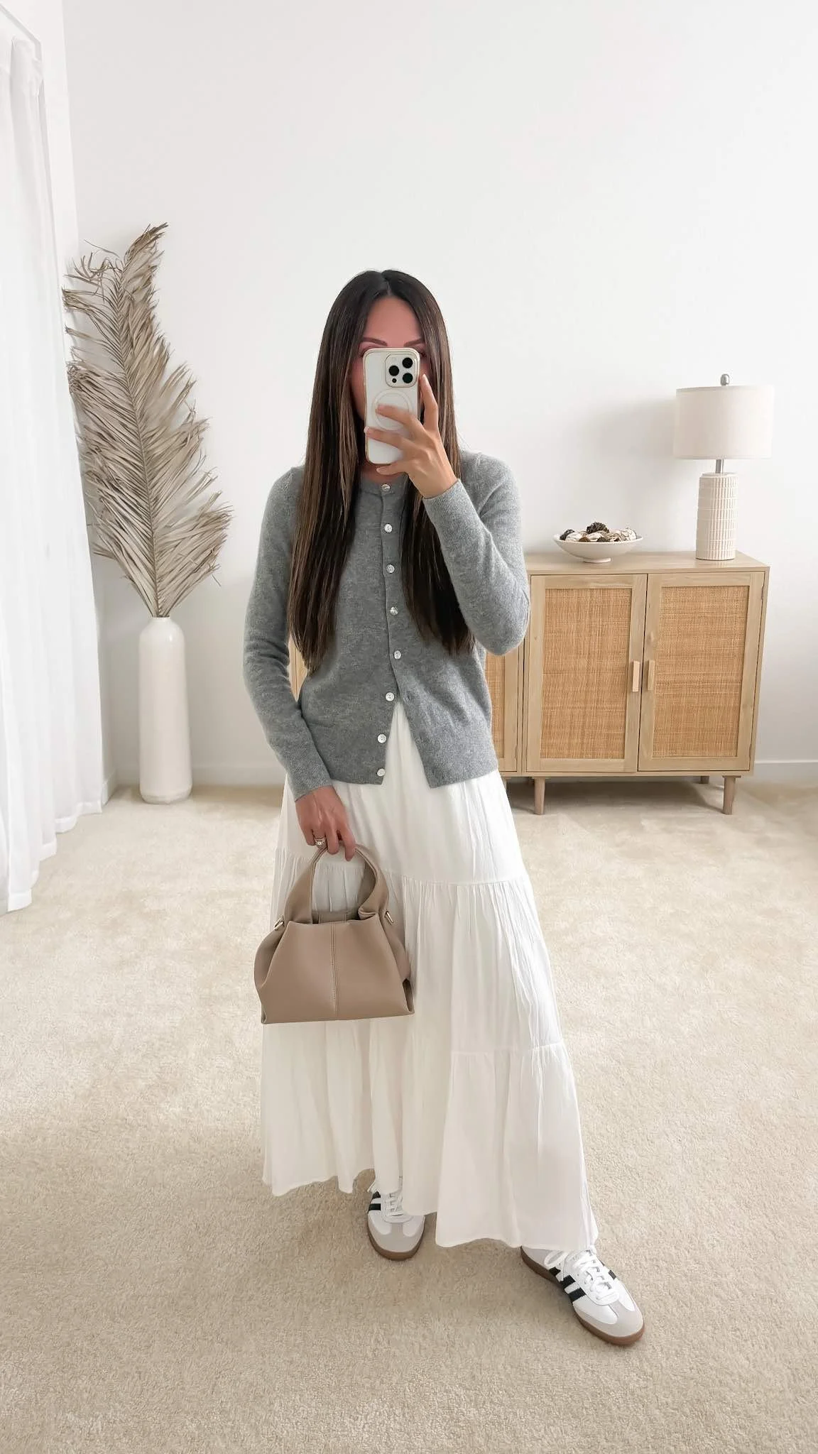 Sweater cardigan with skirt outfit featuring the Quince Mongolian Cashmere Cardigan Sweater styled with a white maxi skirt, sneakers, and a neutral handbag