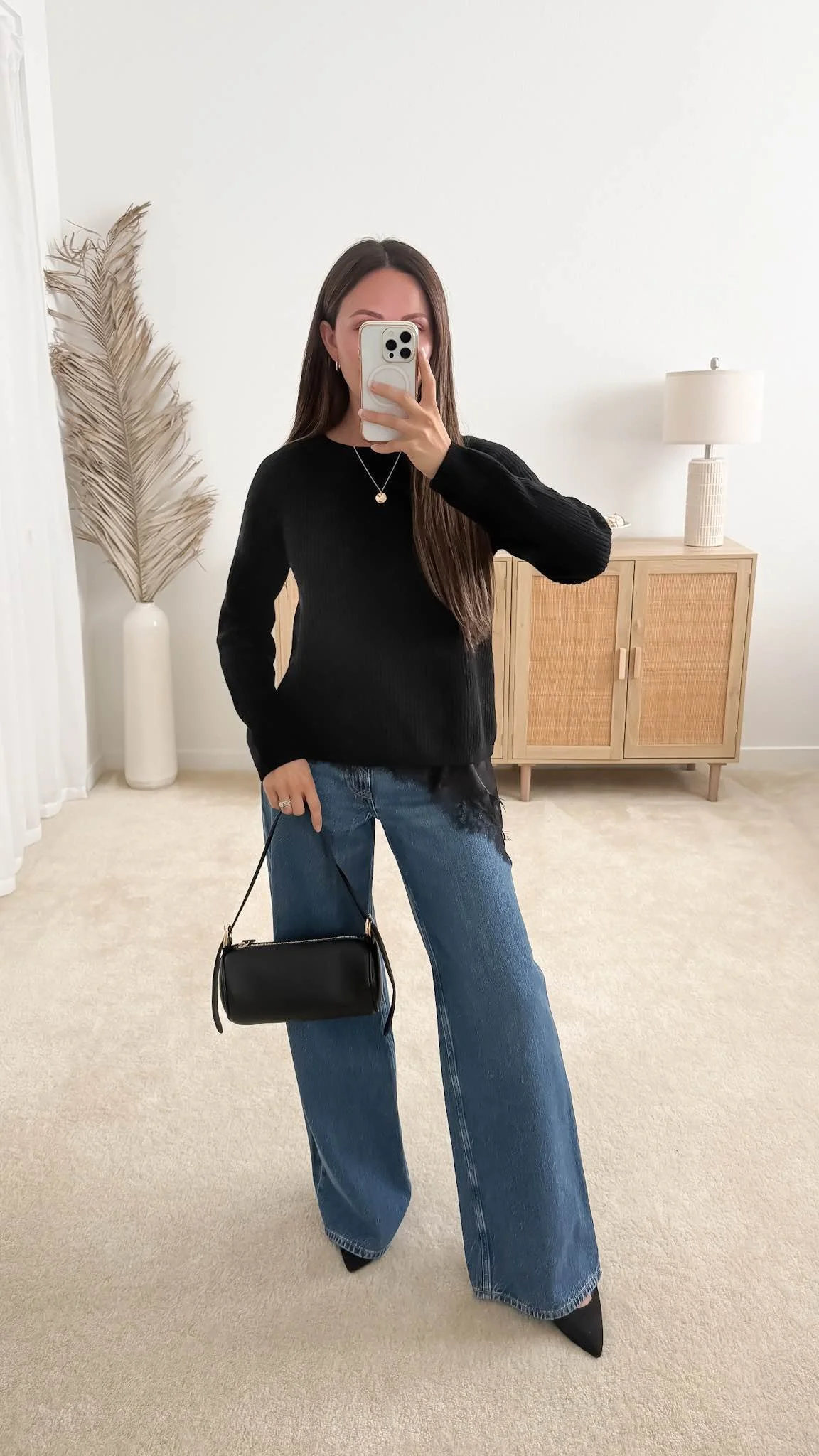 Sweater with wide-leg jeans outfit featuring the Quince Mongolian Cashmere Fisherman Crewneck Sweater styled with a lace hem cami, dark-wash wide-leg jeans, pointed heels, a black barrel shoulder bag