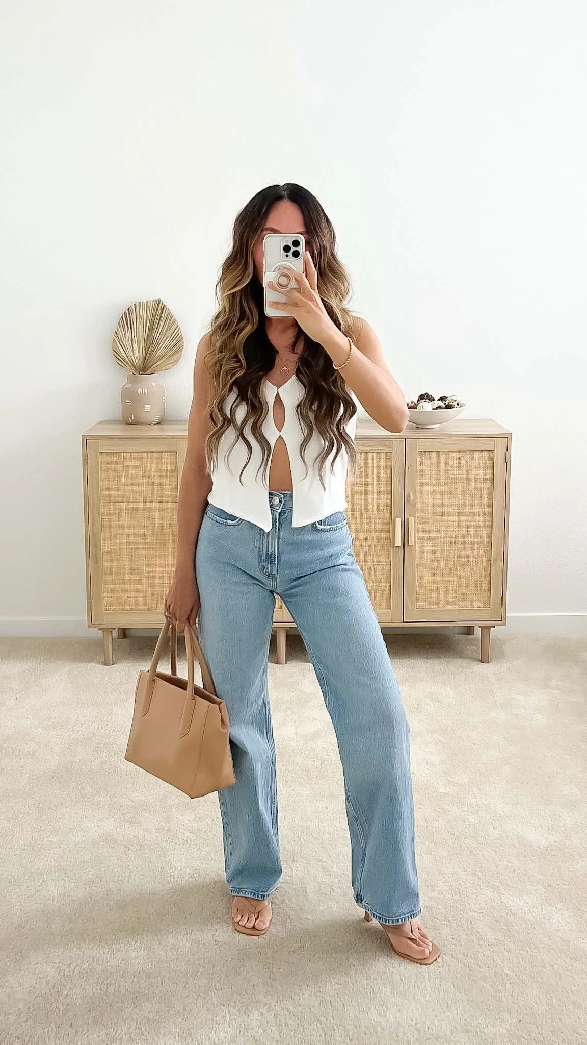 Chic spring outfit with knit button-down vest, light wash jeans