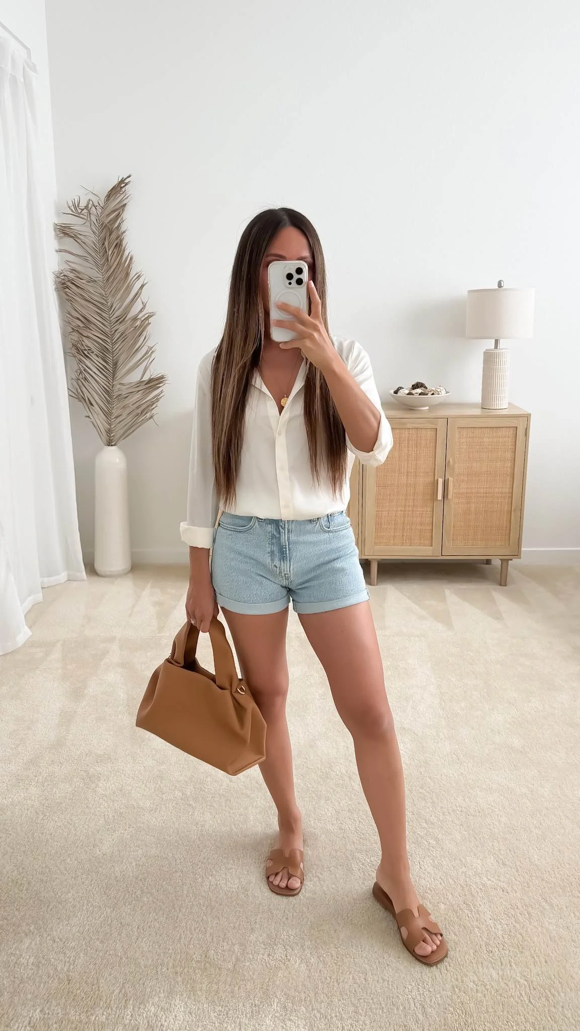 Casual spring outfit with denim shorts, button-down shirt