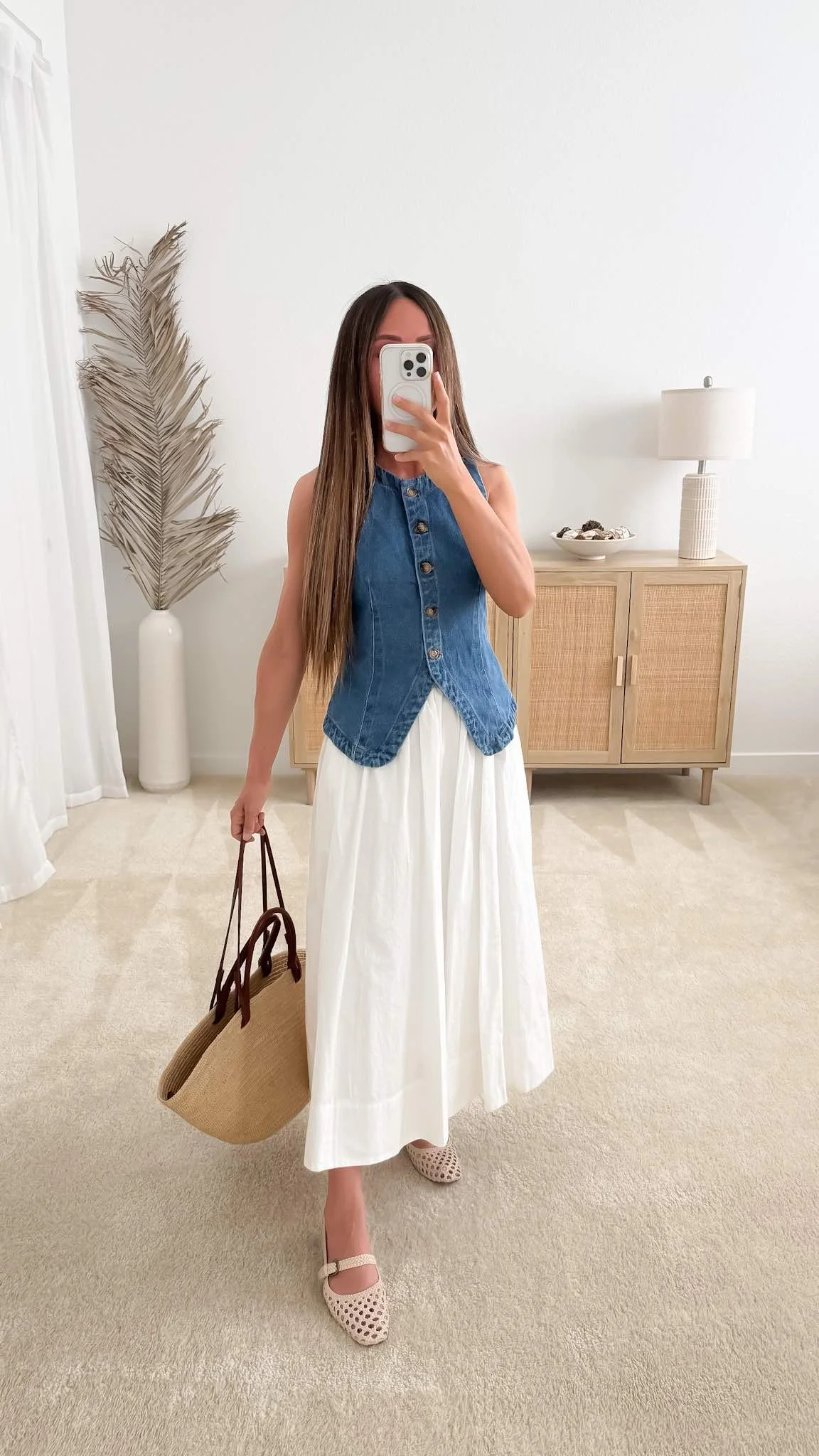 Nicole of Neutrally Nicole styling a denim vest and white cotton maxi skirt with the Sézane Justine basket bag for a neutral spring capsule outfit