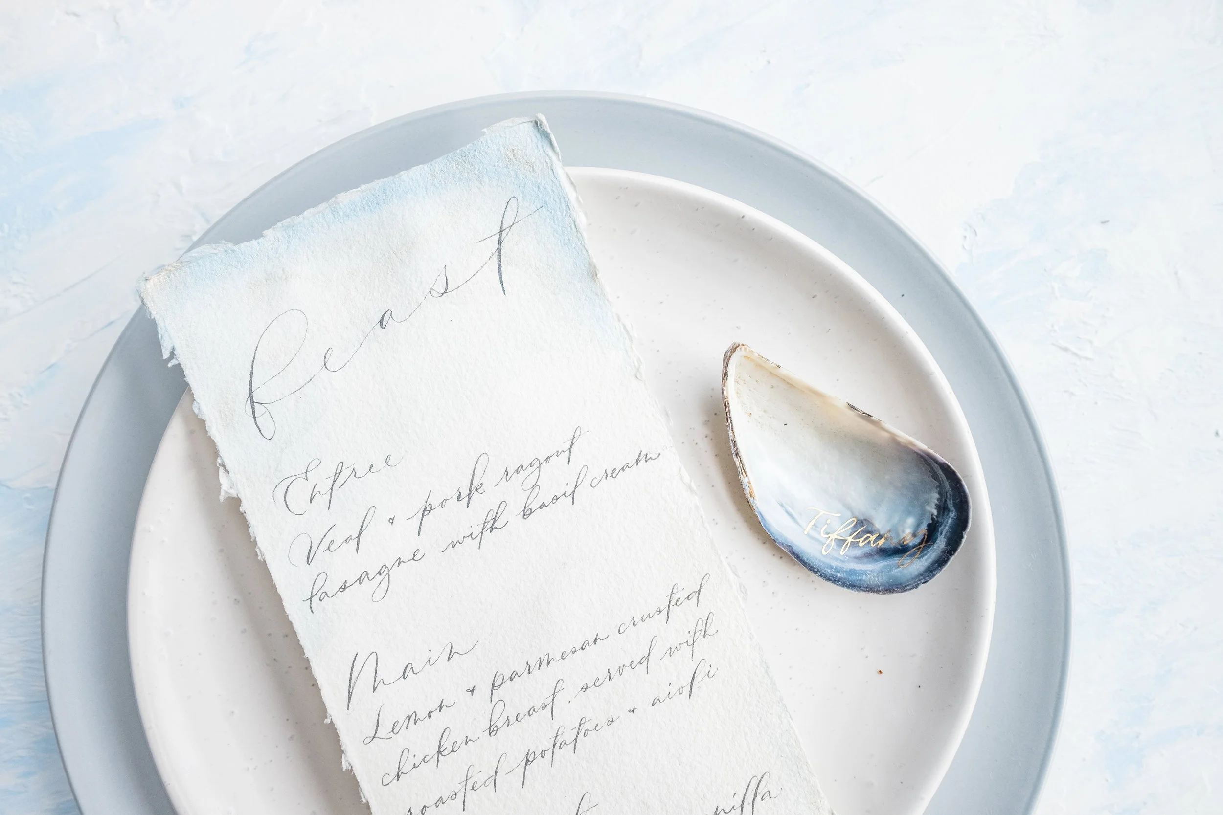 Gold calligraphy on mussel shells