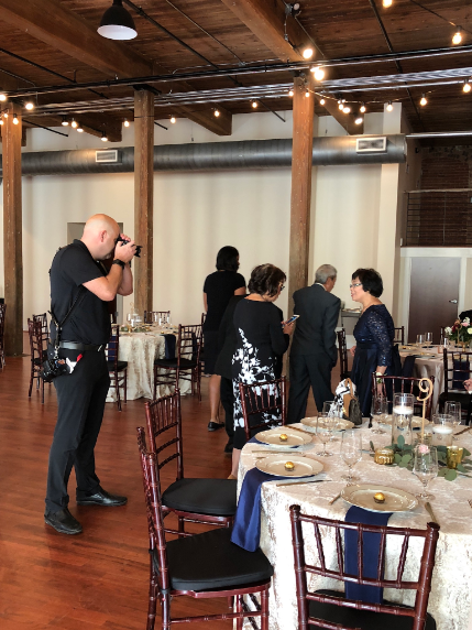 A candid shot of Joe Payne of Joe Payne Photography taking candid shots of family members before the ceremony.