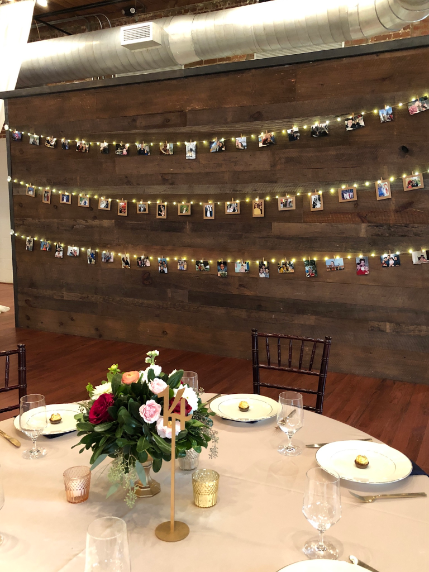 On the wall behind this lovely table setting are rows of multi-generational wedding photos from Anthony’s and Lynn’s families.