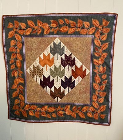 A beautiful quilted fall wall hanging or table topper.