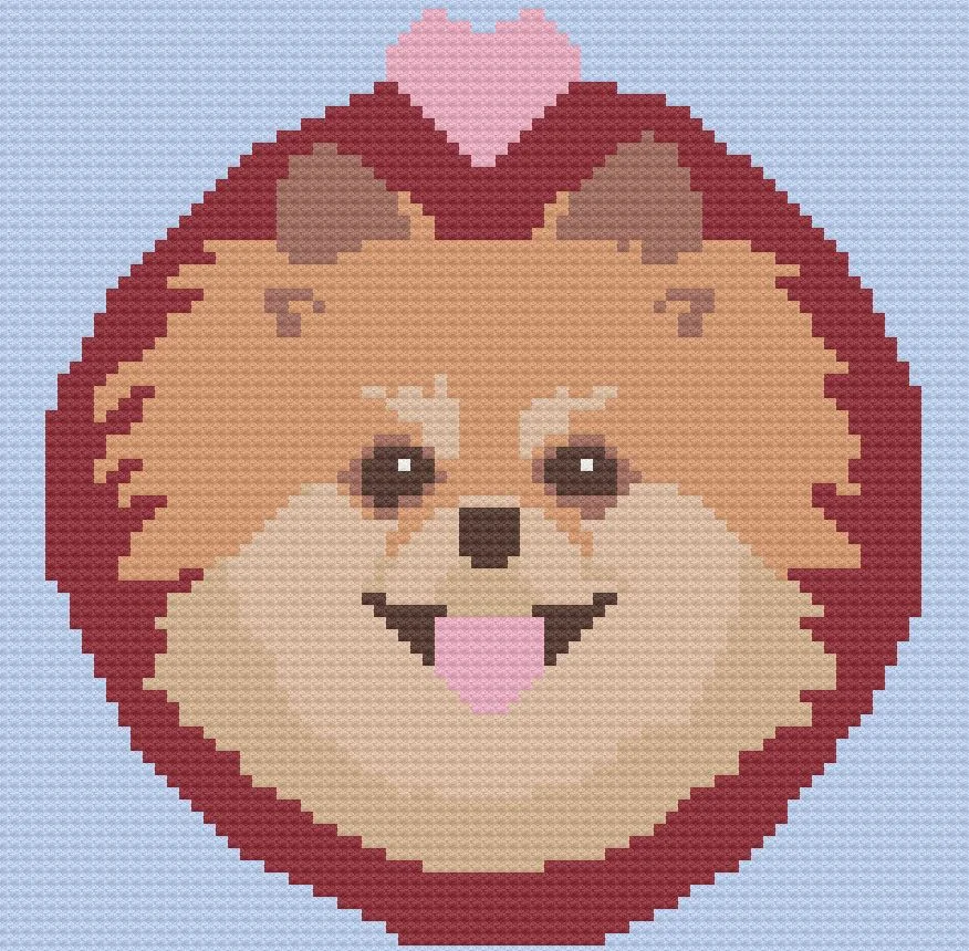 A crochet afghan featuring a detailed Pomeranian dog face with a fluffy coat and a pink heart above its head, set against a light blue background.