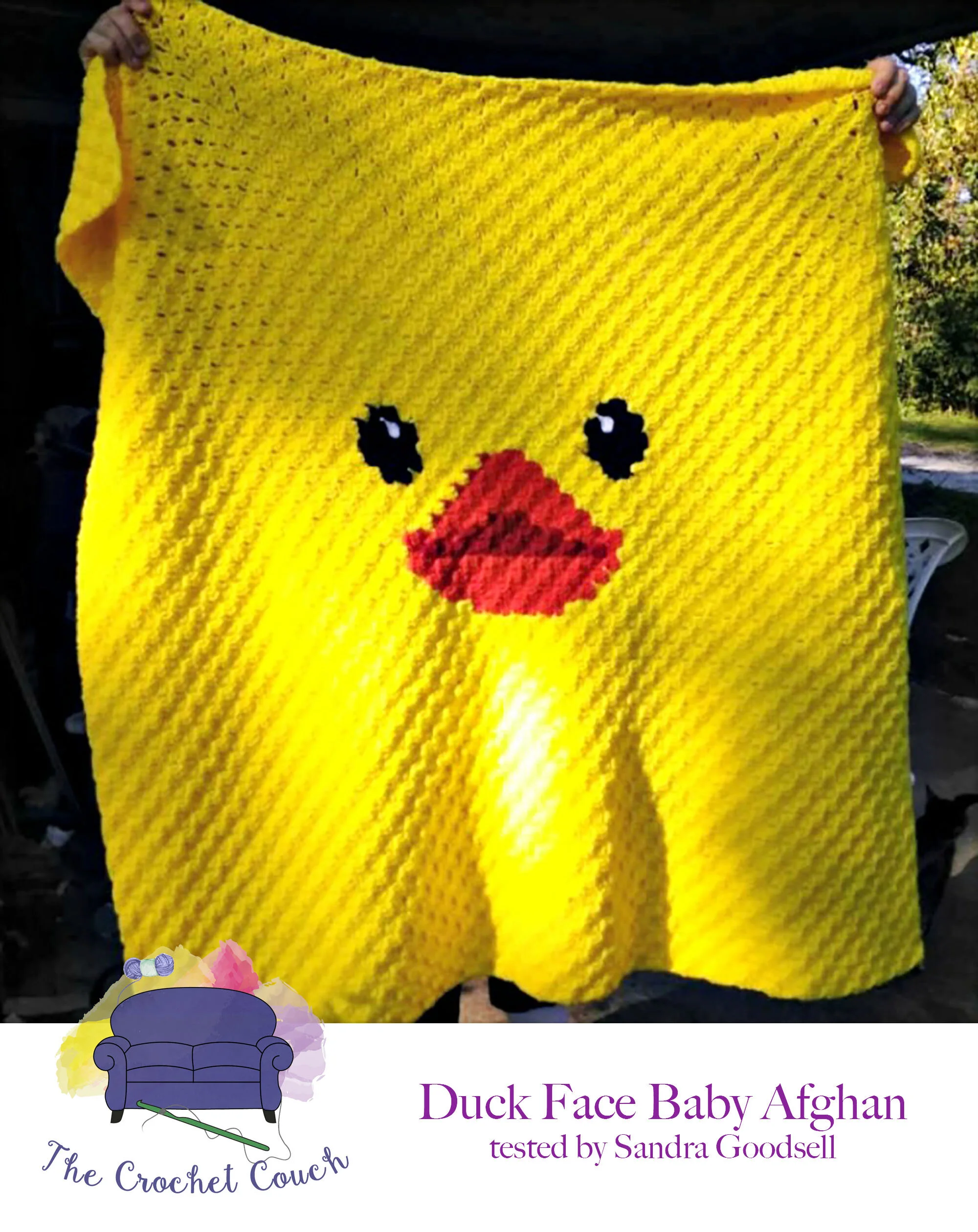 Afghan being held up that shows a closeup of duck face - afghan is done in primarily yellow with a small spot in the middle for the face.  Afghan is crocheted using the c2c technique