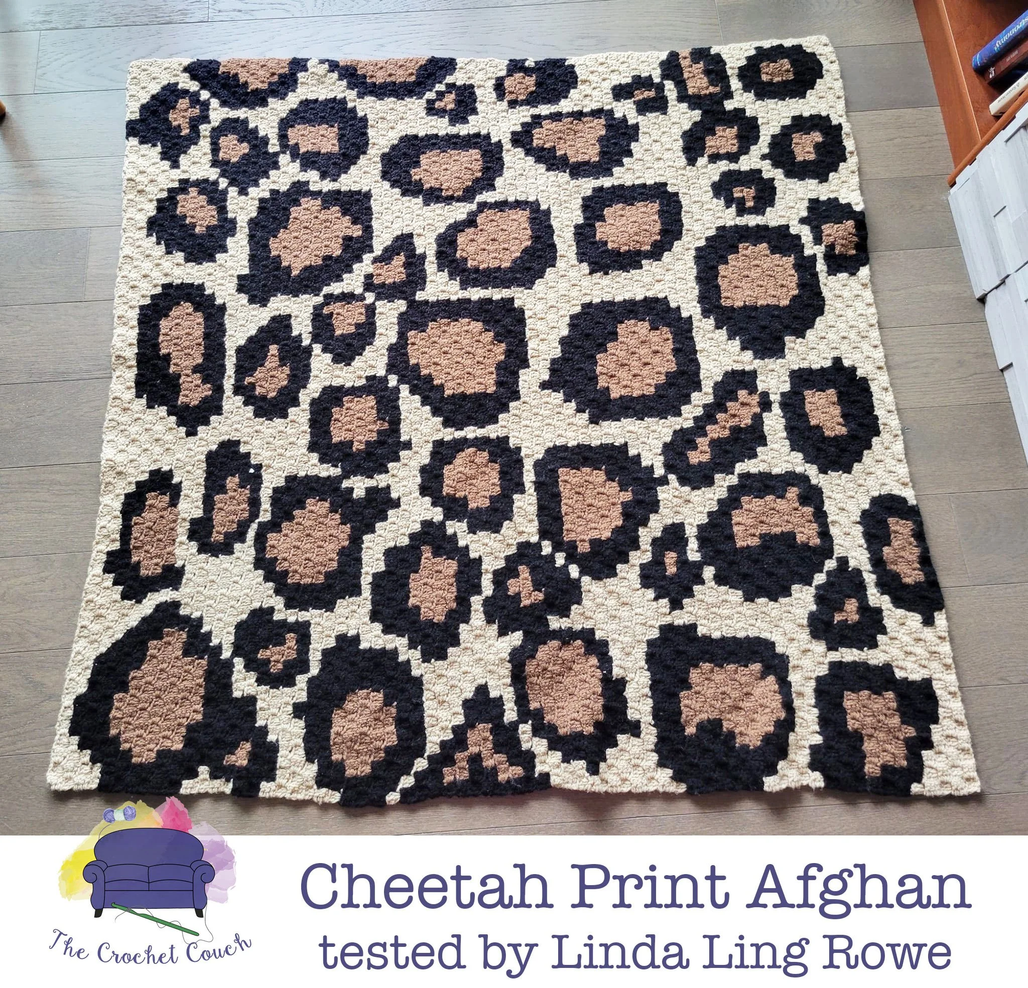 Crocheted afghan is shown laying on wood floor - afghan is a C2C with a cheetah print pattern and crocheted by Linda Ling Rowe