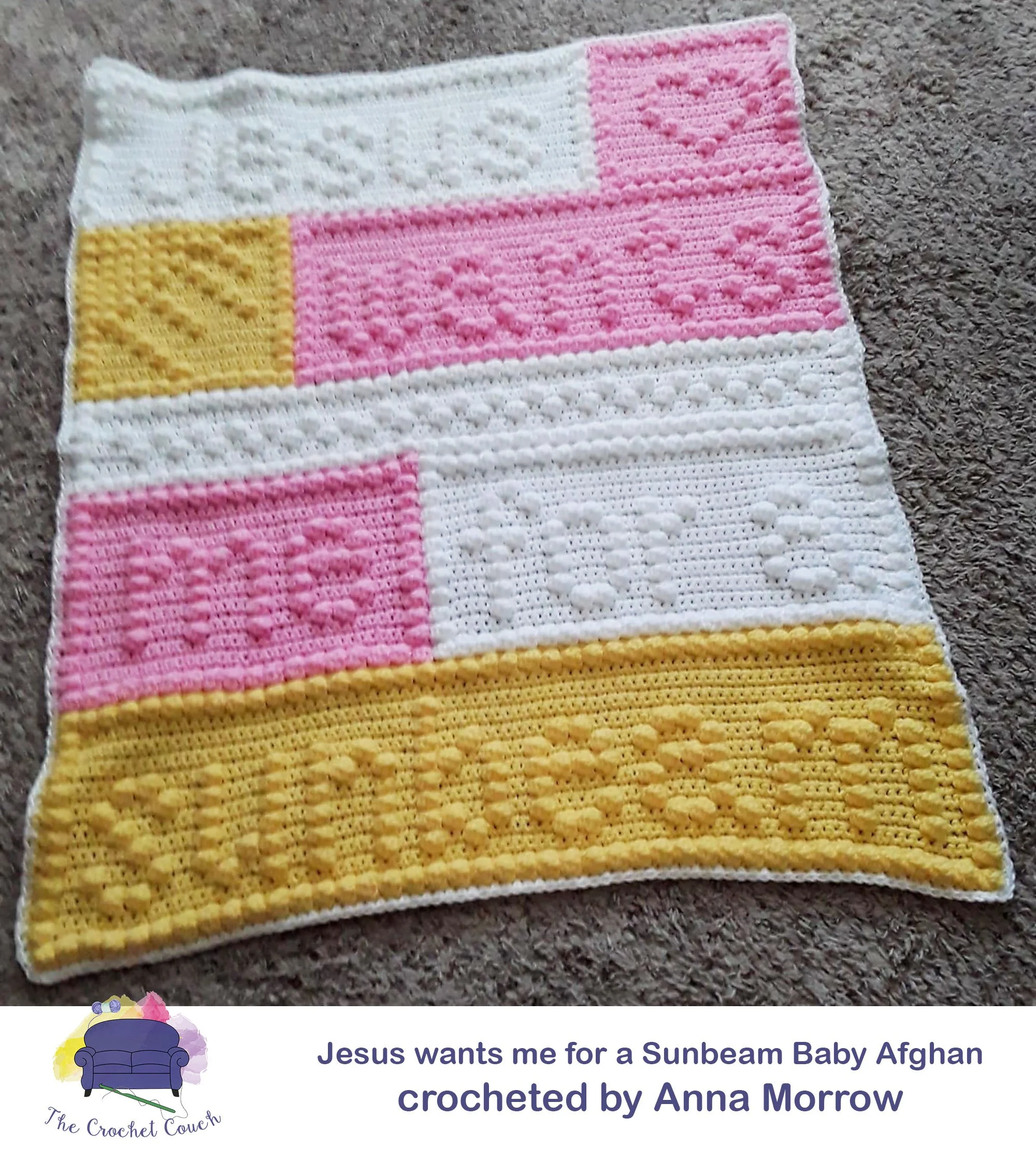 Afghan shown laid on carpet - it’s a bobble stitch baby afghan done in pink, white and yellow.  The bobbles form a design and have the words Jesus wants me for a sunbeam.