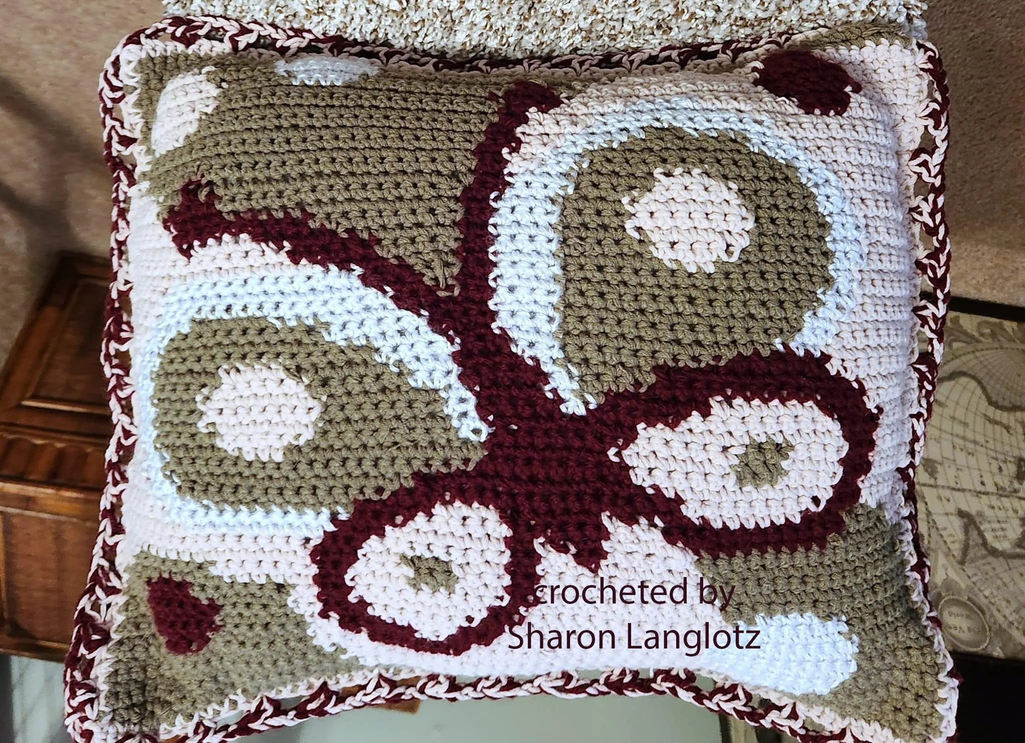 Photo shows a crocheted butterfly pillow in pink, white, taupe and burgundy done entirely in single crochet.  Pillow was crocheted by Sharon Langlotz