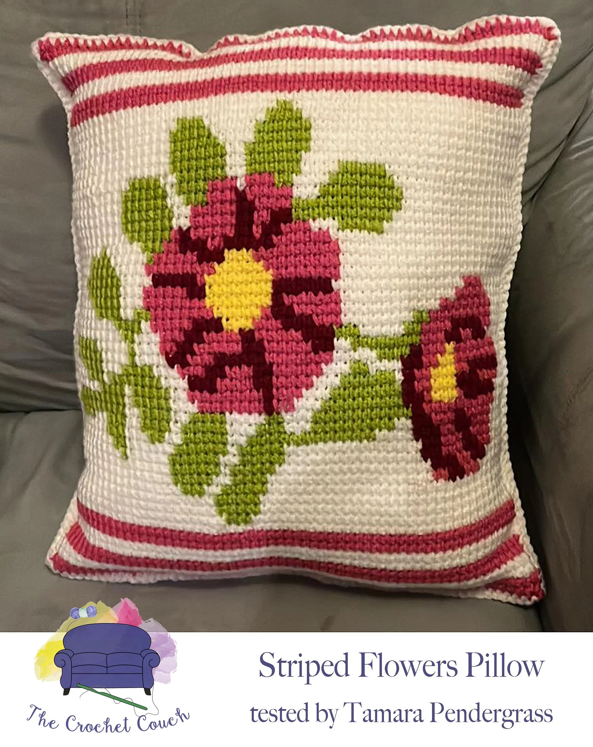 Photo shows  pillow crocheted using Tunisian Simple Stitch (TSS) The pillow has a white background, rose colored stripes at the top and bottom, two flowers with green leaves in the center.