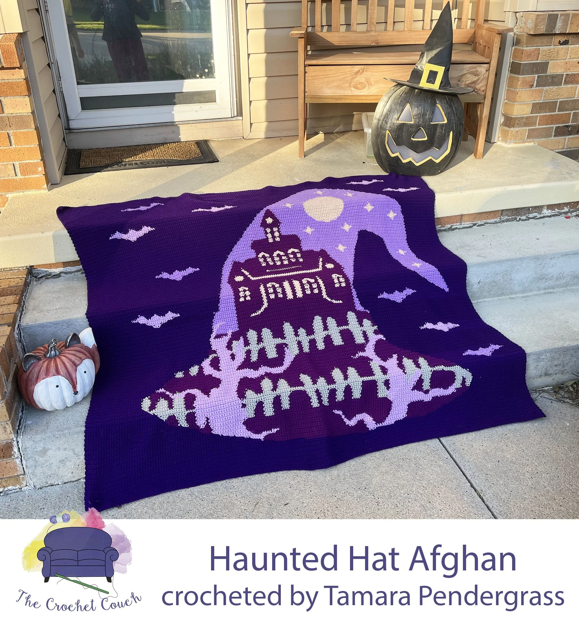 Crocheted afghan is shown draped over front porch stairs with other Halloween decor  - it depicts bats flying around a witch’s hat that has haunted house graphic in the hat silhouette.