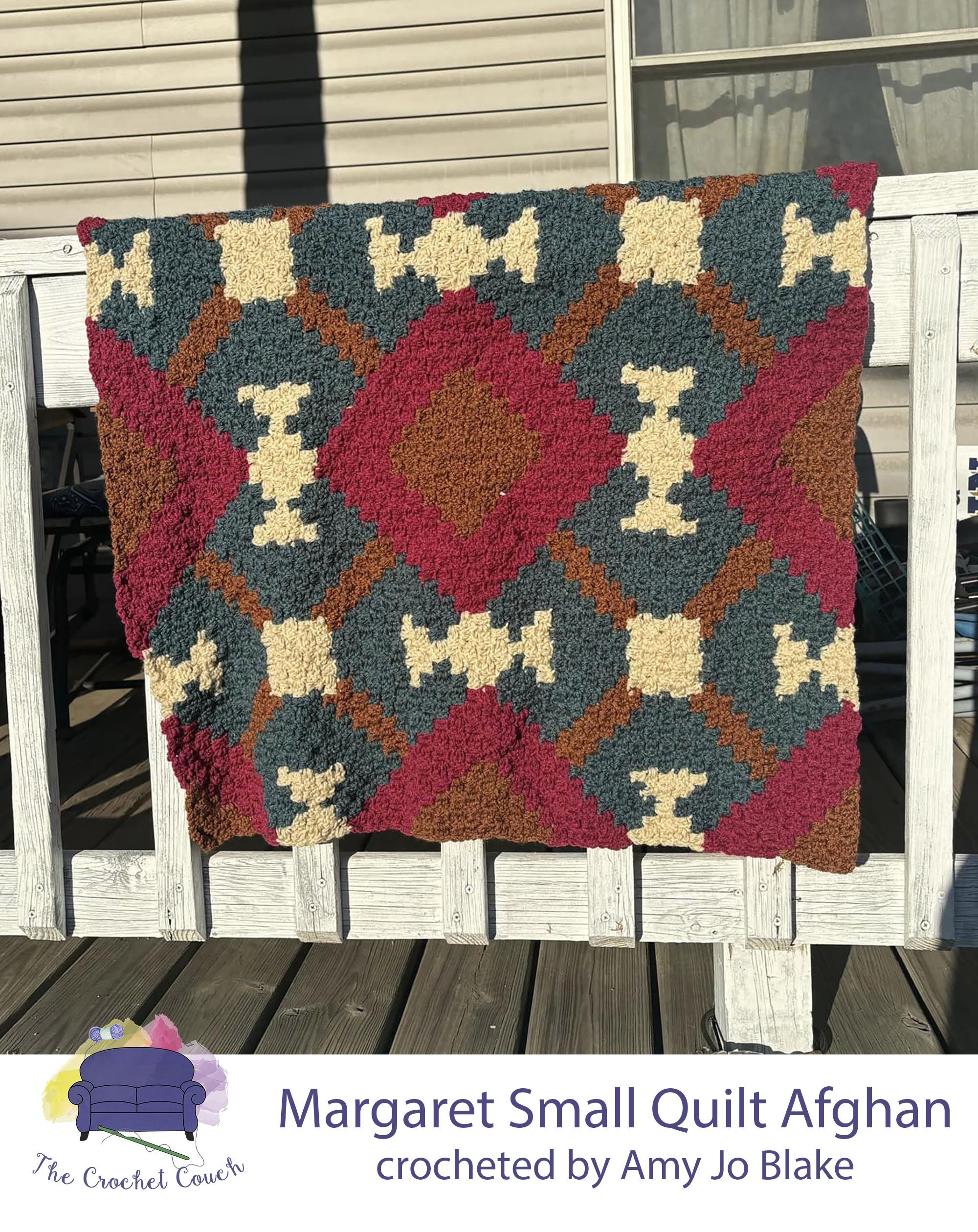 Crocheted afghan is shown draped over front porch railing  - afghan is done in colors of azure, garnet, cocoa and linen and is a quilt pattern   Afghan was crocheted using C2C by Amy Jo Blake