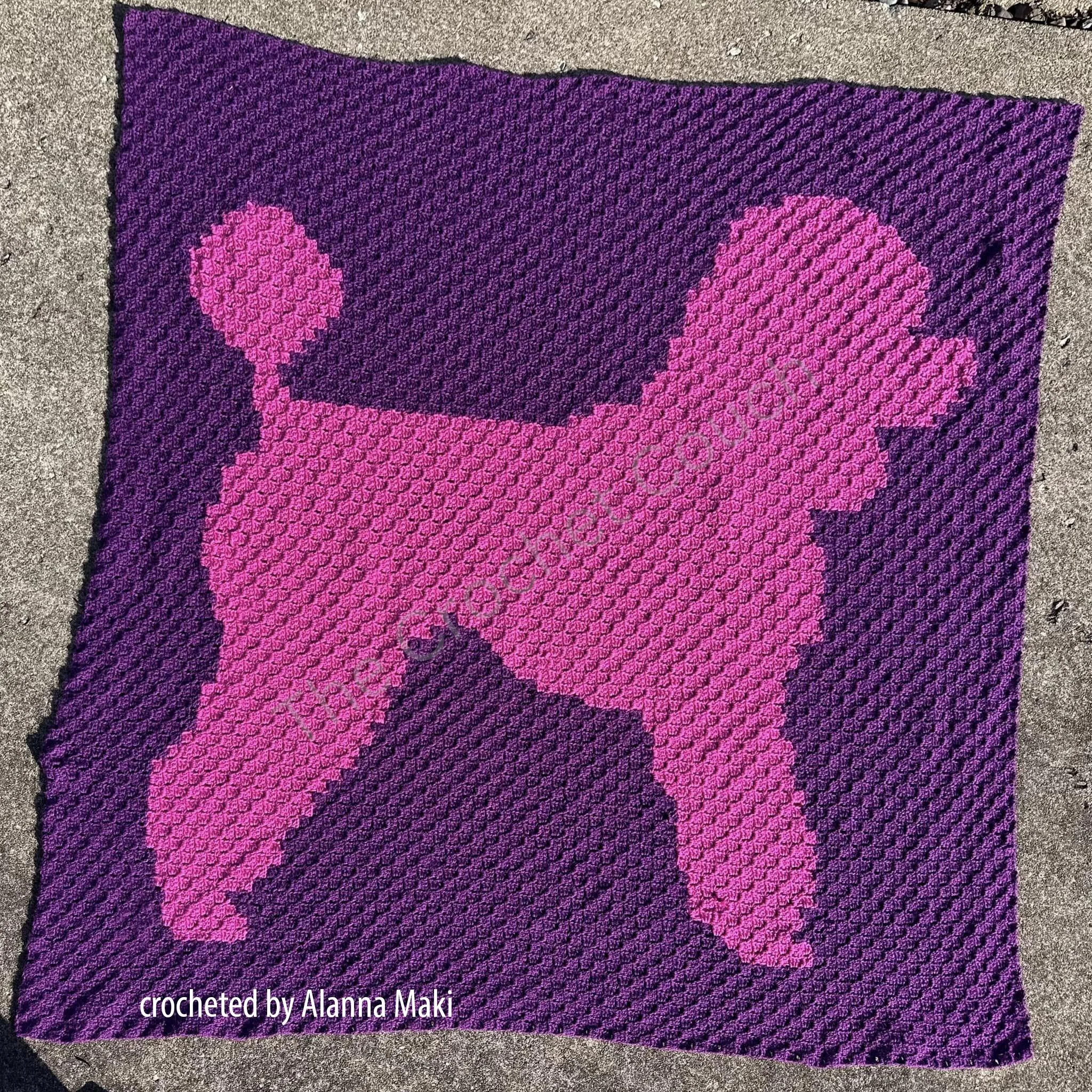 A vibrant purple and pink crochet afghan featuring a bold poodle silhouette