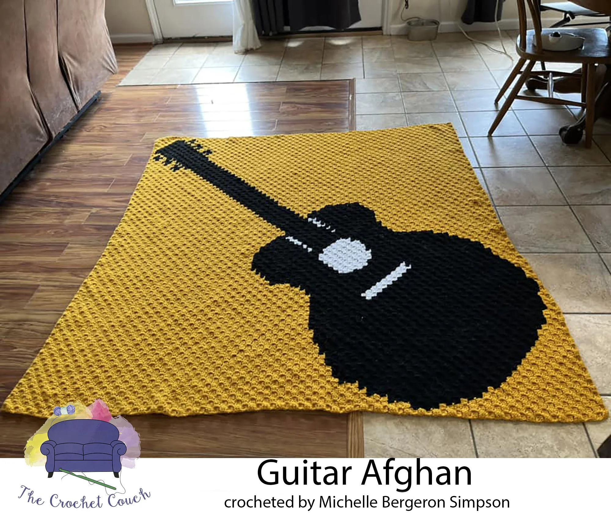 Crocheted Afghan done in C2C, shown laying on the floor.  The afghan depicts a black guitar silhouette on a gold background.