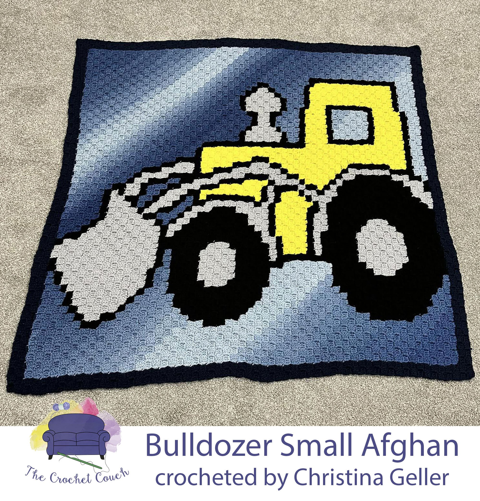 Crocheted Afghan shown laying on floor - depicts a yellow bulldozer on a fading blue background.  Afghan was crocheted using C2C method by Christina Geller