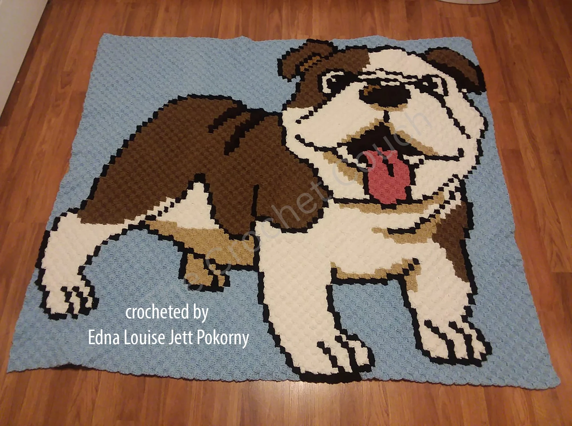 Crocheted English Bulldog afghan featuring a large, playful bulldog on a light blue background.