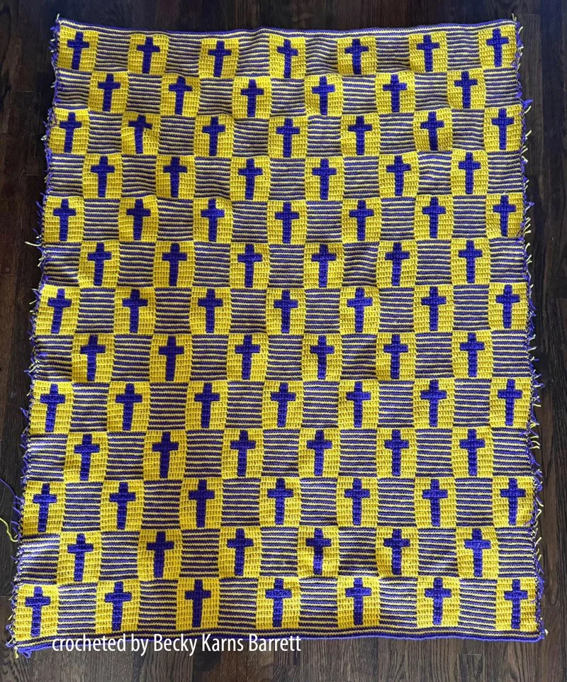 A crochet afghan featuring a repeating pattern of bold crosses in a mosaic crochet design.