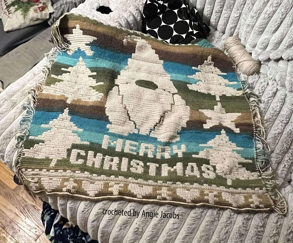 Crocheted afghan in overlay mosaic featuring a large white gnome with pointed hat, surrounded by Christmas trees on a striped background