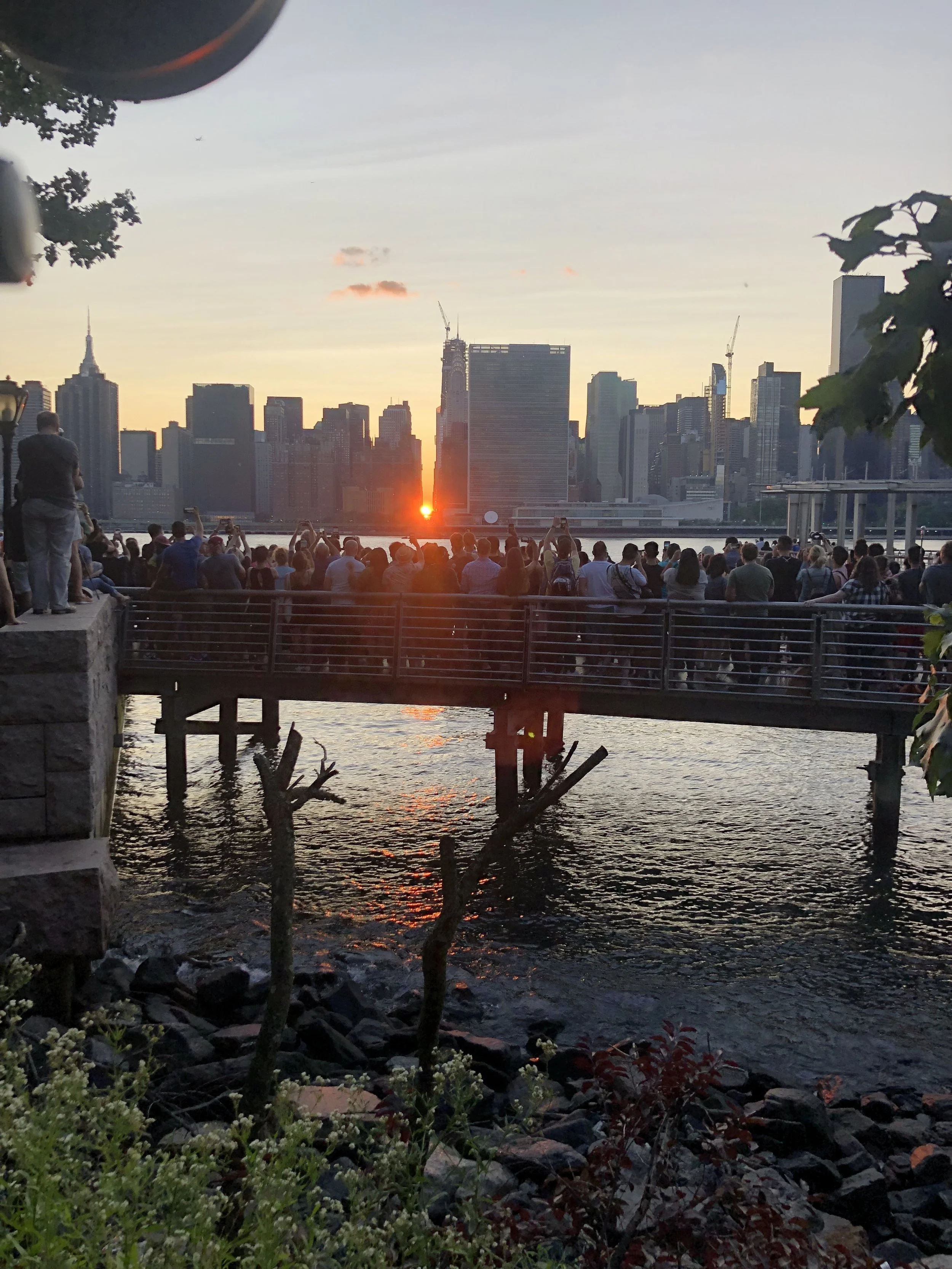 iPhone image provided by Ivan Ferrera . Tourists take photos of the setting sun, shot from Gantry Plaza State Park, Long Island City.