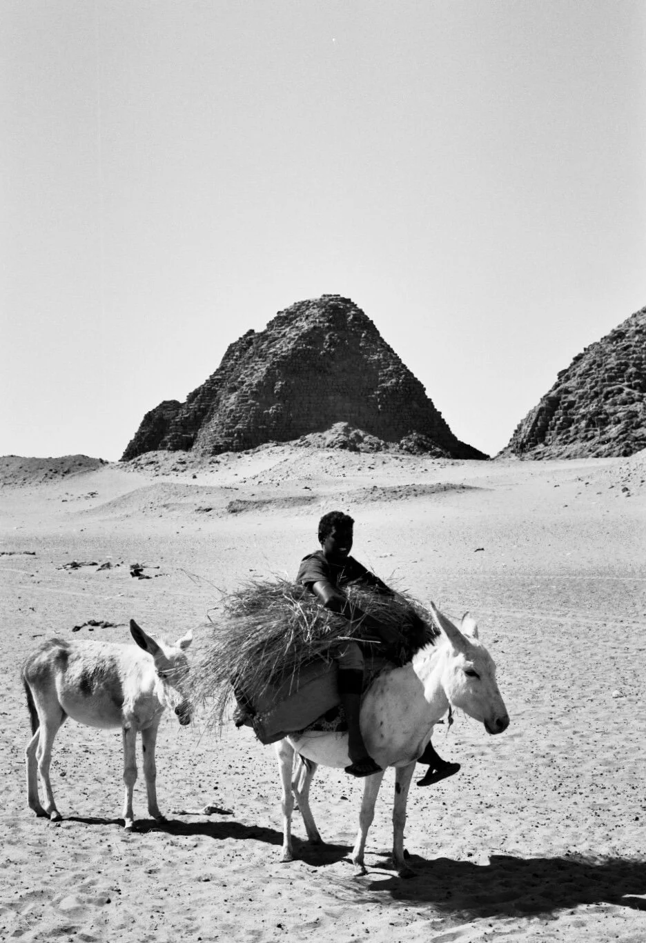 a boy poses in front of the Nuri Pyramids. Ilford Delta 100
