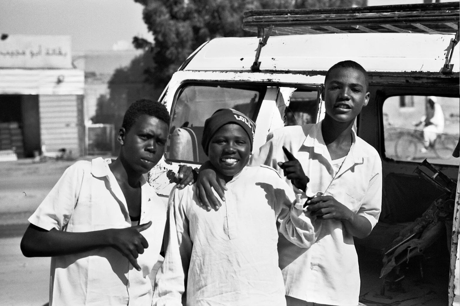 Boys Pose for a photo at a bus stop. Ilford Delta 100.