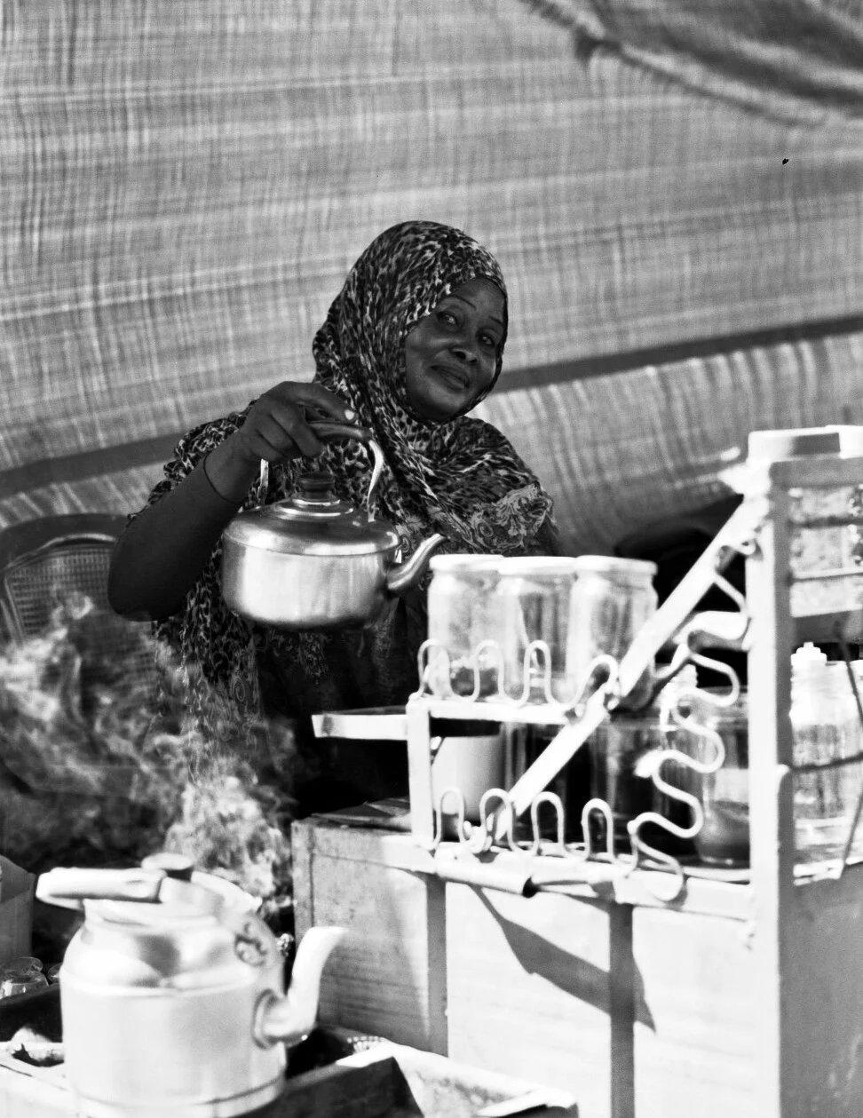 A woman selling Tea on the street. Ilford Delta 100