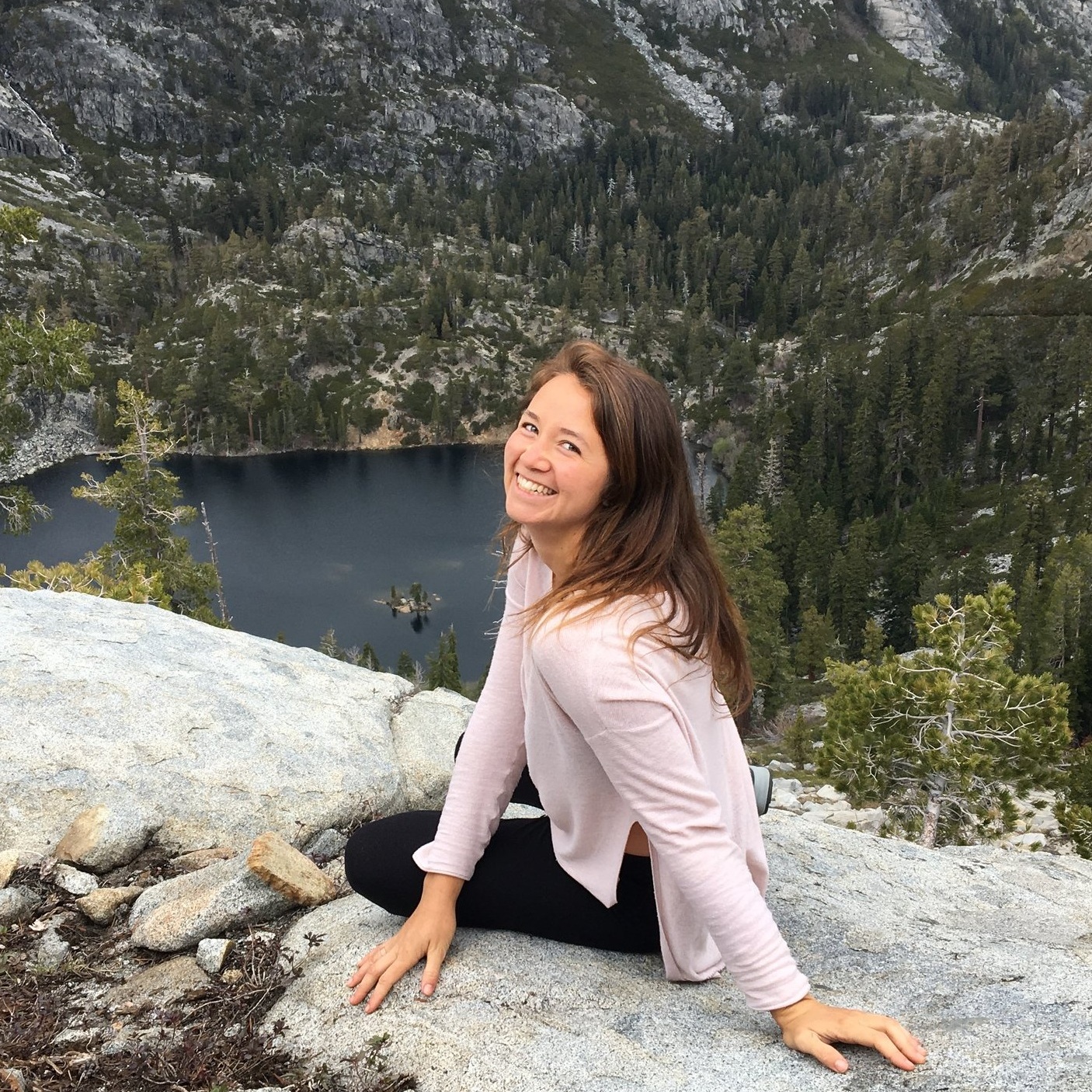 Sophia+Gonzalez+sitting+on+a+mountain+cliff+smiling+back+at+the+camera.+She+shares+a+testimonial+about+working+with+Jennifer+Spoelma+as+a+Career+Decision+Coach.jpg