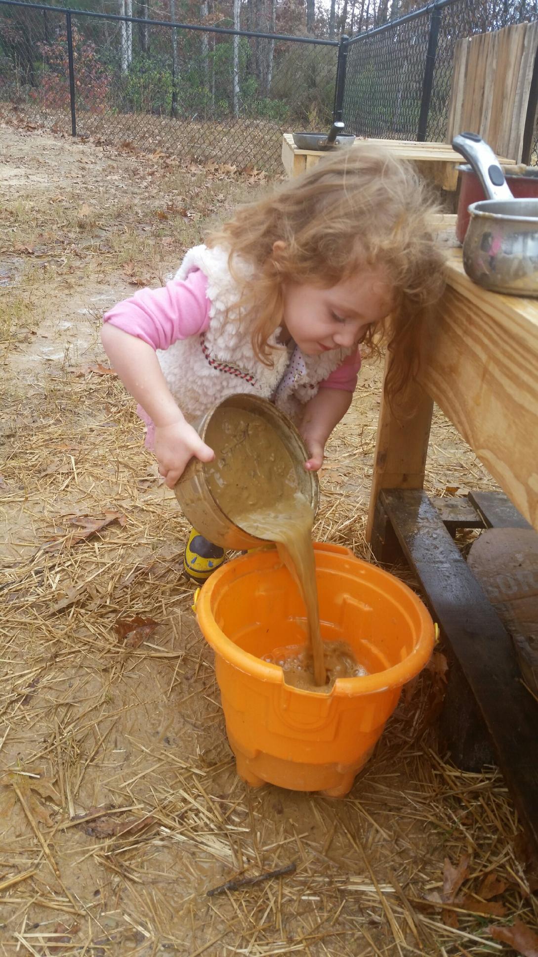 Kinley pouring mud.jpg