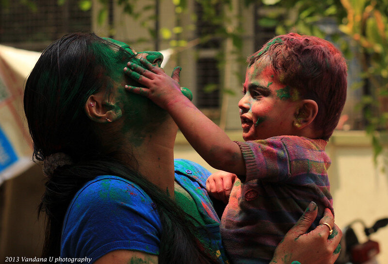 Child applying Holi color