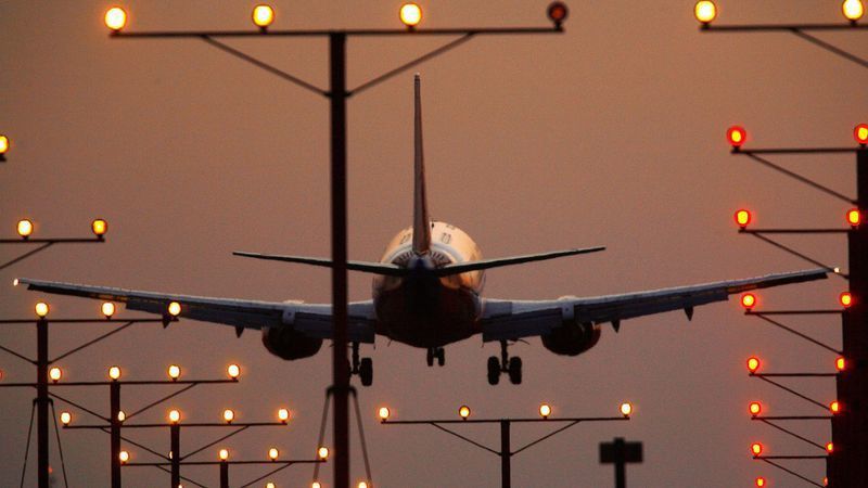 A jet descends into Los Angeles International Airport. New flight paths into LAX, redrawn by the FAA to save fuel and reduce delays, have prompted the city to sue the federal agency. (David McNew / Getty Images)