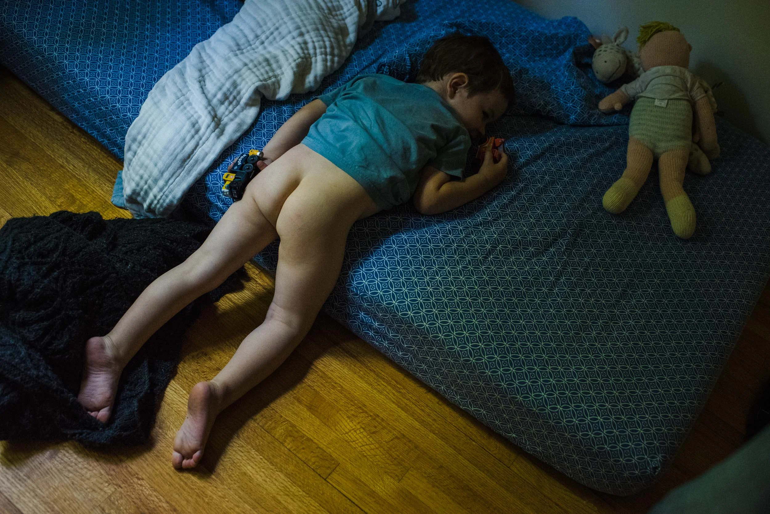 boy asleep on his bed next to his stuffy