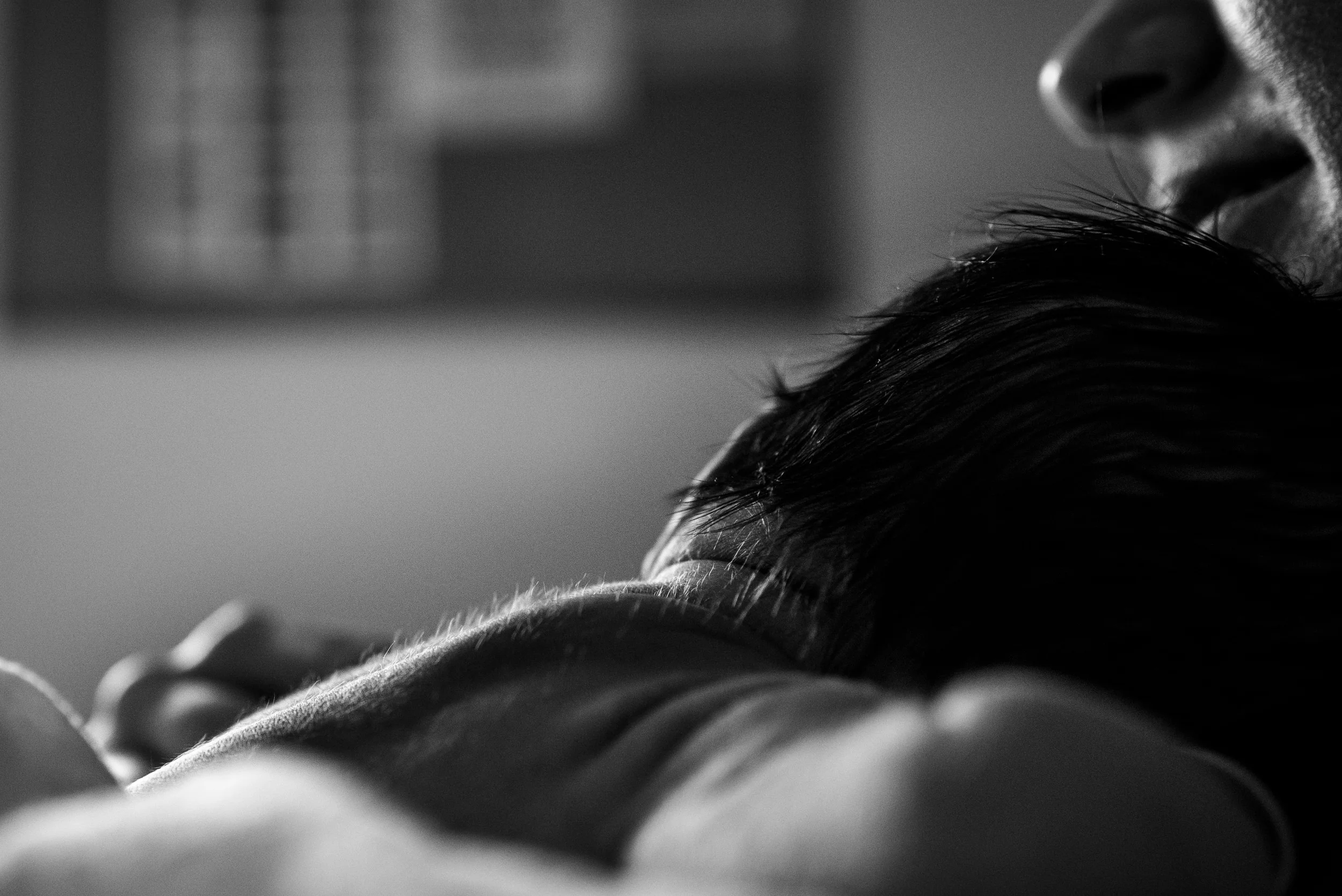 Newborn baby laying on mother's chest at the hospital, Vancouver. Photograph by Felicia Chang.