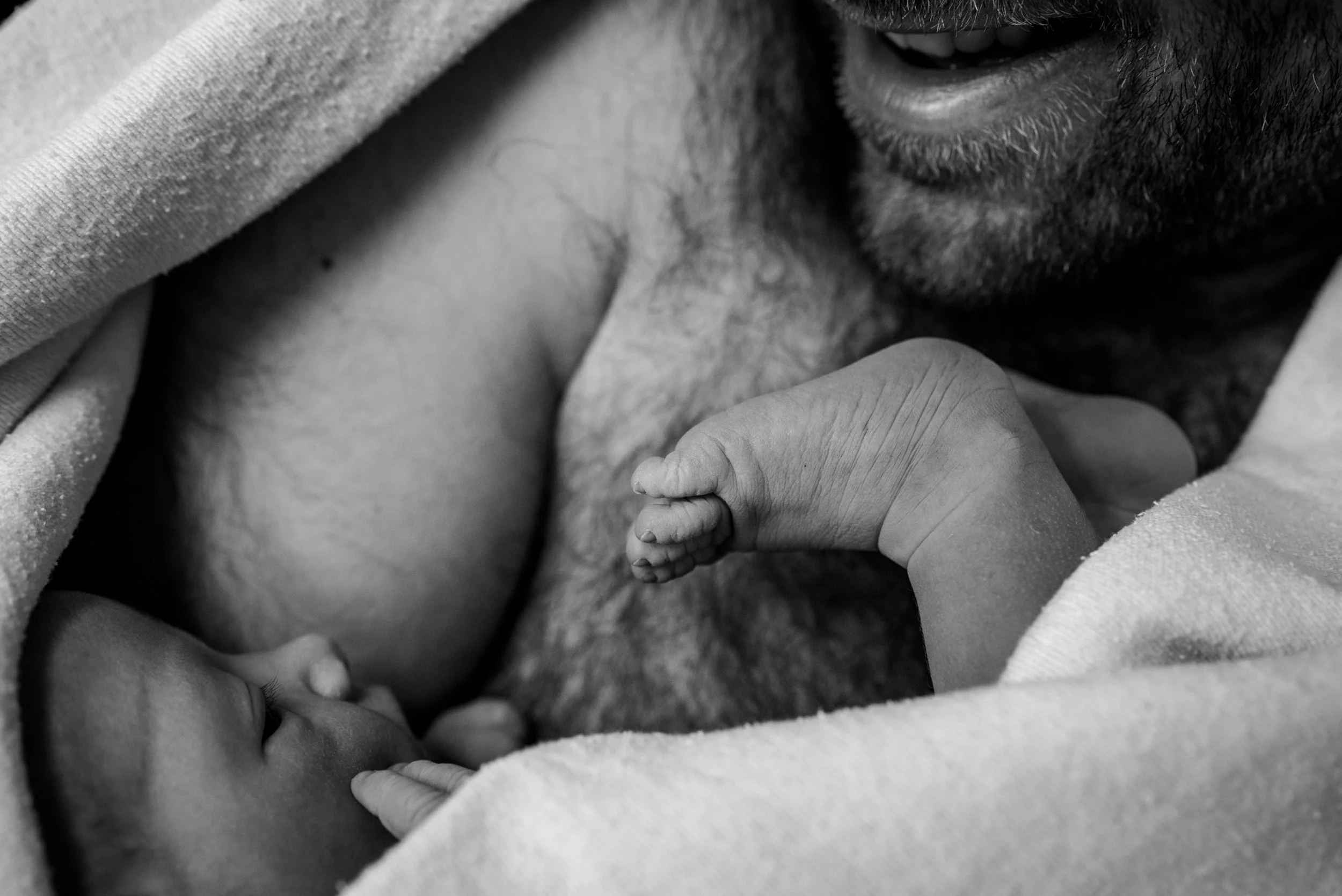 Dad having skin-to-skin with his newborn baby girl at the hospital after c-section. Fresh 48 hospital newborn photography by Felicia Chang.
