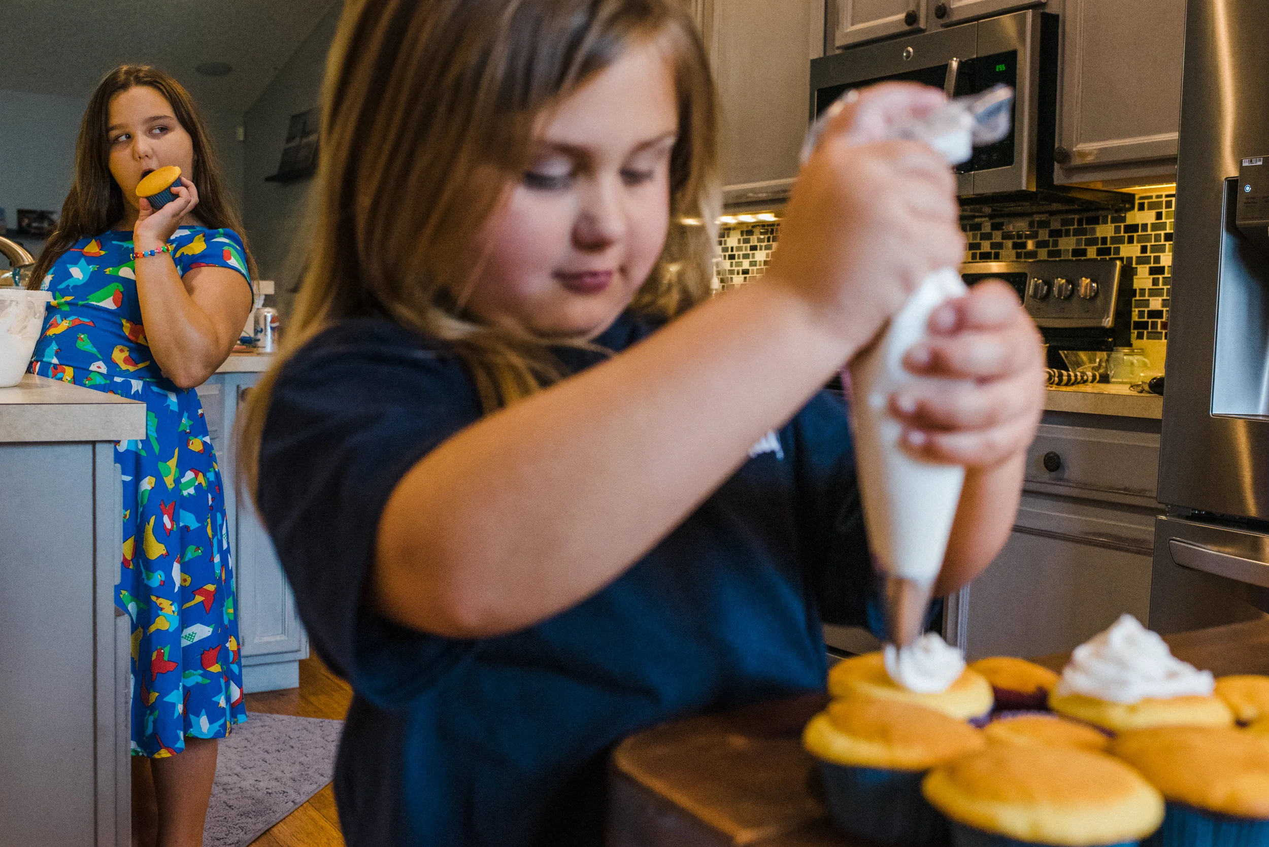 Everyday life photos. Sisters making muffins together in the kitchen.