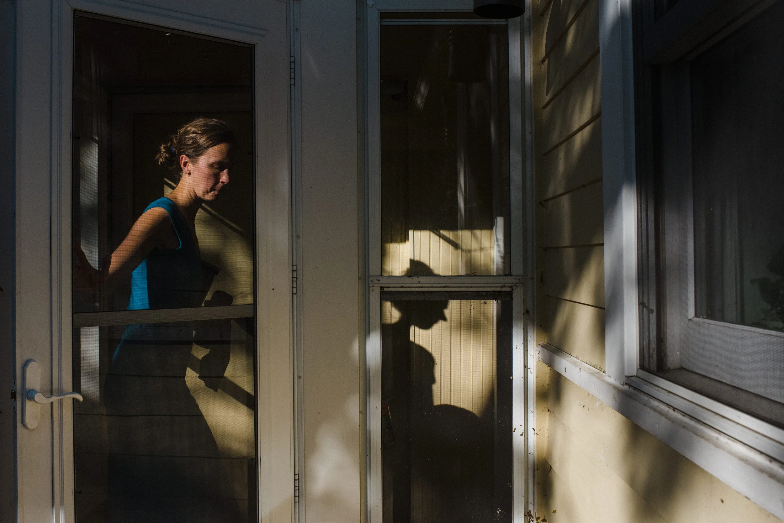 Day in the Life Family. Mother heading into the house while the sun is setting.