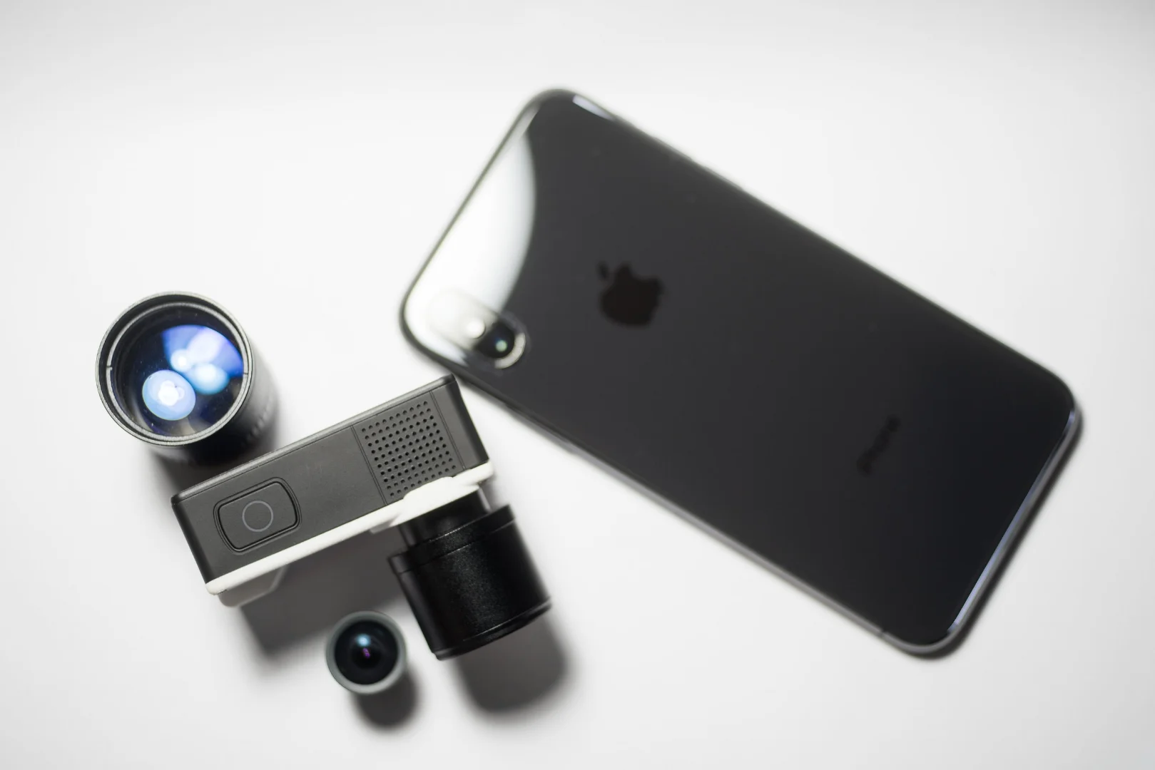 NANO1 with assorted lenses with Apple iPhone X (TM) for size comparison