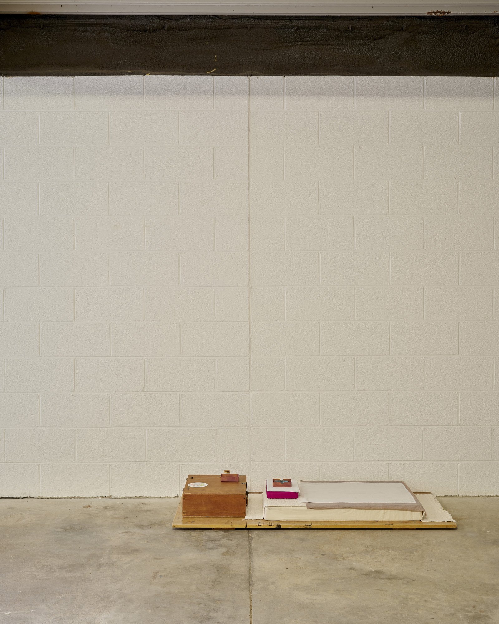   Aleana Egan ,  Bruno , 2026. Wooden box, pencil, tiger balm, foam, card, cotton, linen, wood, 27 x 75 x 160 cm. Installation view, Interface, Inagh. Courtesy of the artist and Kerlin Gallery. Photograph by Ros Kavanagh. 