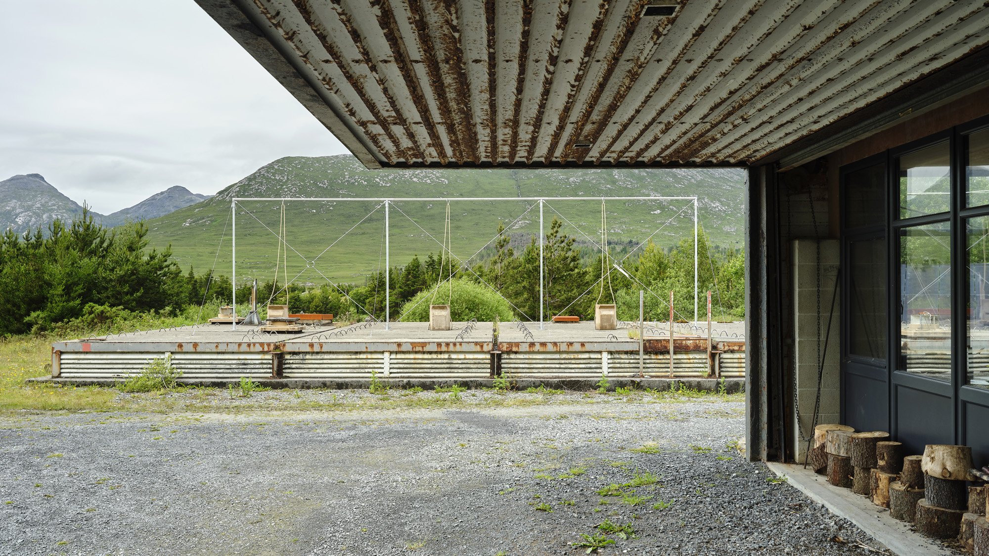   Aleana Egan ,  earlier things , 2026. Galvanised steel, hemp rope, fire backs, 300 x 1070 x 510 cm. Installation view, Interface, Inagh. Courtesy of the artist and Kerlin Gallery. Photograph by Ros Kavanagh. 