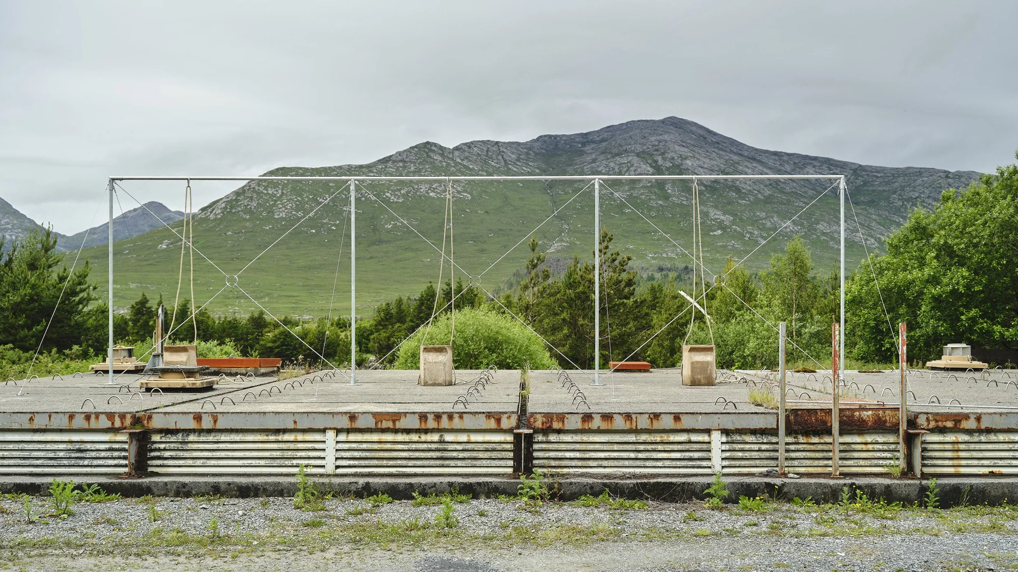   Aleana Egan ,  earlier things , 2026. Galvanised steel, hemp rope, fire backs, 300 x 1070 x 510 cm. Installation view, Interface, Inagh. Courtesy of the artist and Kerlin Gallery. Photograph by Ros Kavanagh. 