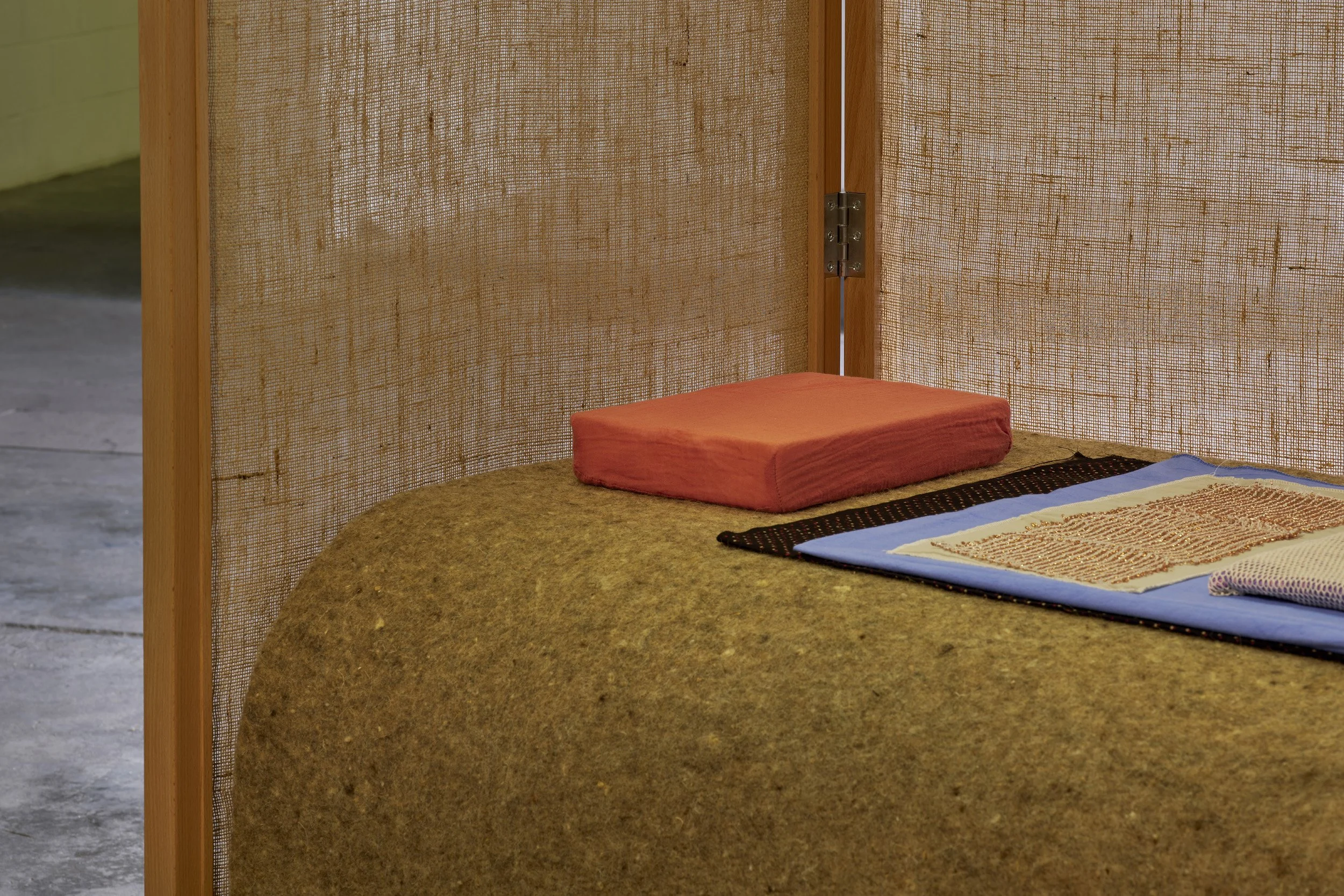   Aleana Egan ,  lit-clos , 2026 (detail). Beech frame, hessian, wool, linen, various dyed cotton and muslin fabrics, latex, pigment, shell, foam, copper (four parts), 180 x 160 x 390 cm. Installation view, Interface, Inagh. Courtesy of the artist an
