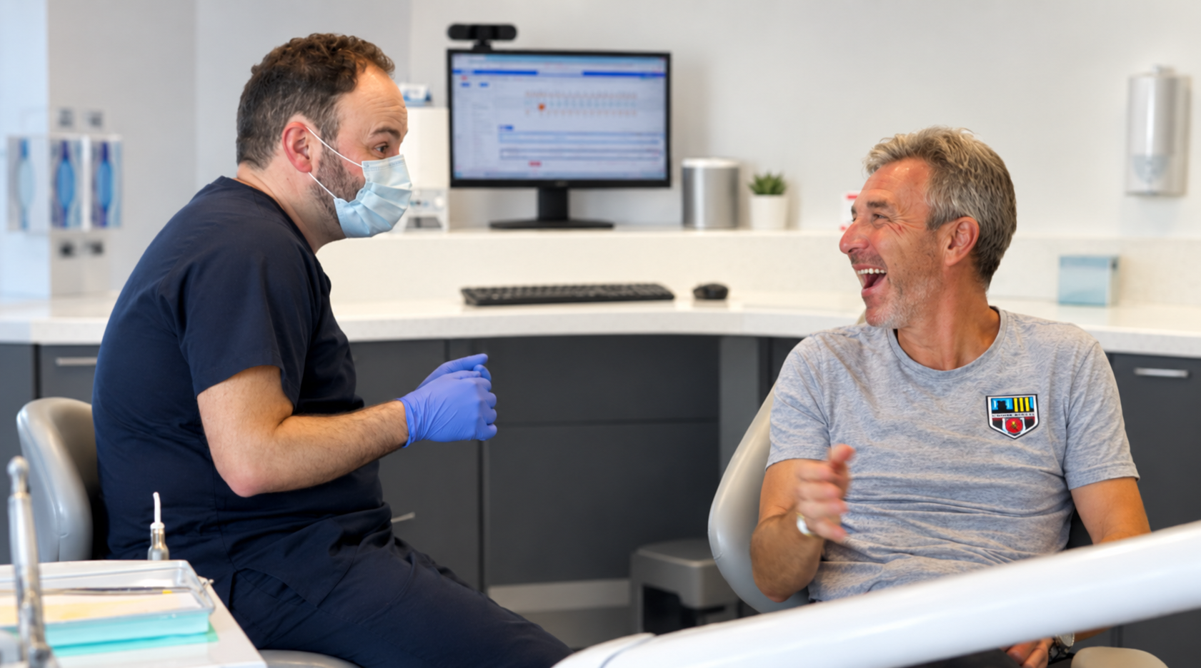 Patient laughing with his dentist during a visit to The Lytham Dental Clinic in Lytham St Annes.