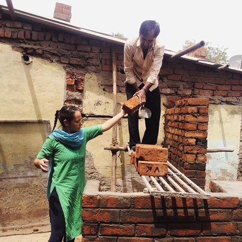 03_Bholu 15_Niini passing recycled bricks to bricklayer copy.jpg