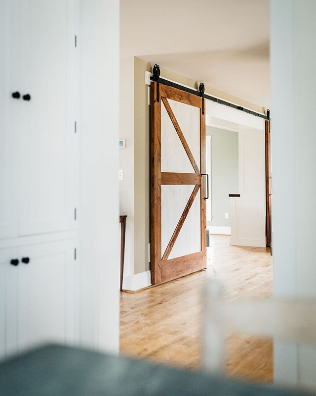 One of our favorite details from a recent home remodeling project.&nbsp; A long-time friend and client had us install these classic looking barn doors to separate the living spaces.

Glancing out from the kitchen, we love how the wood pairs with the 