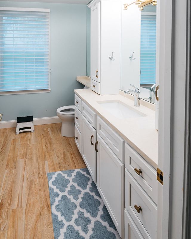 Glancing into a recently renovated master bathroom for a client in Pikesville.&nbsp; We added a few storage options and went with a lighter tile floor that has the appearance of wood planks to make the space feel a little brighter. Really happy with 