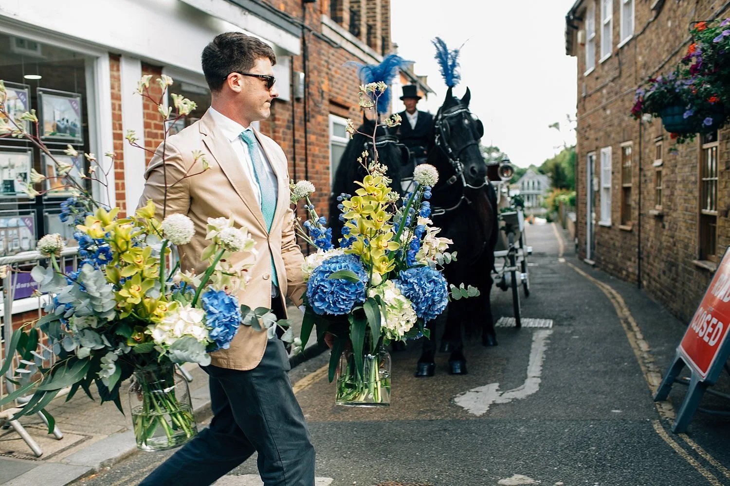 Horse-drawn wedding carriage travelling through Twickenham
