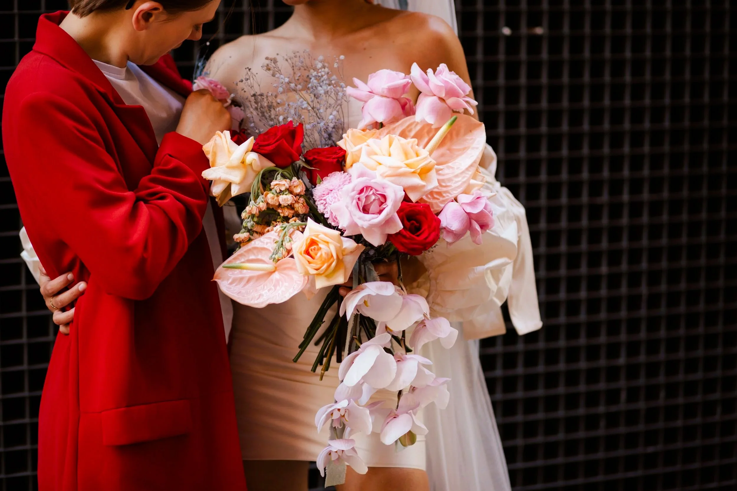 Two brides with colourful wedding flowers